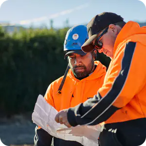 Two construction workers looking at a plan