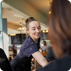 A hospitality worker serving customers 