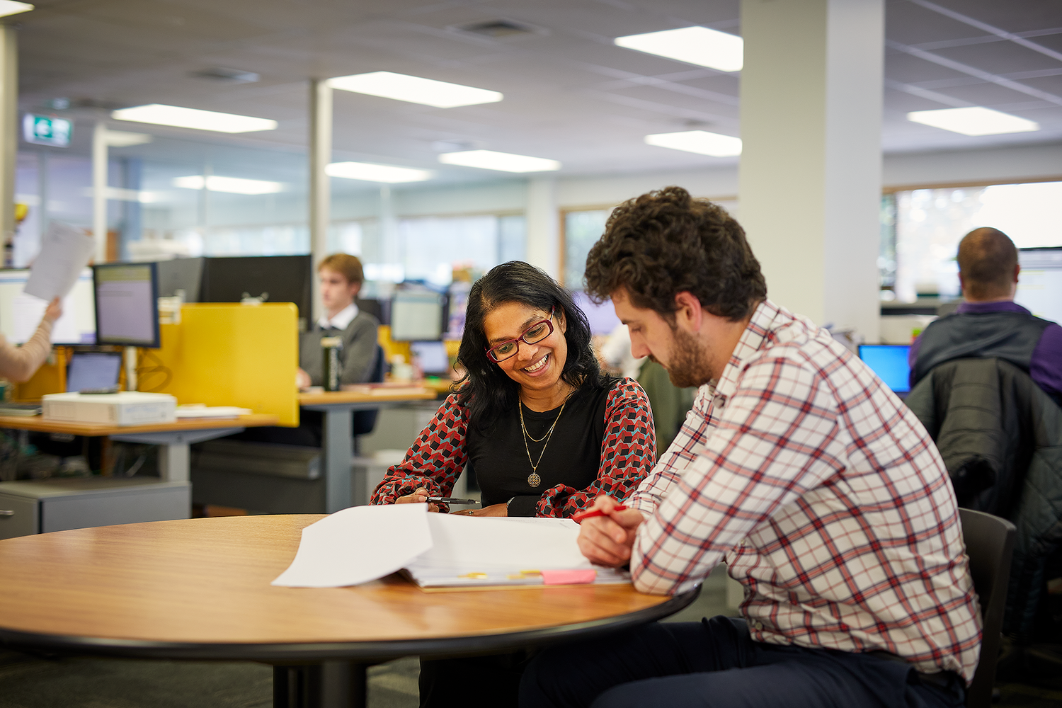 Two people looking at a book