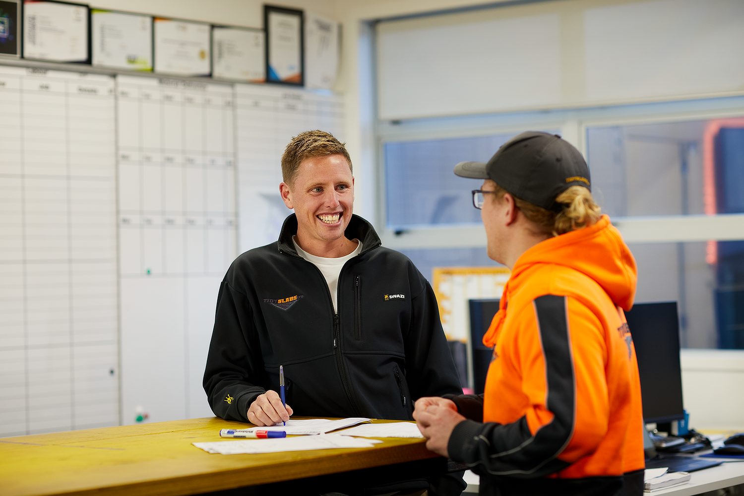 Two construction workers talking together