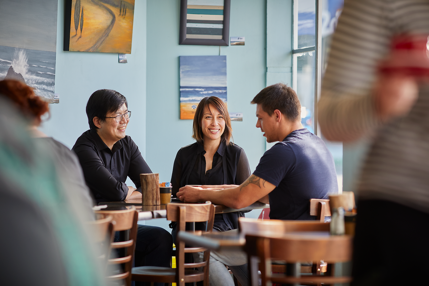 Three people talking in a café