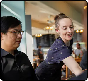 A hospitality worker serving customers 